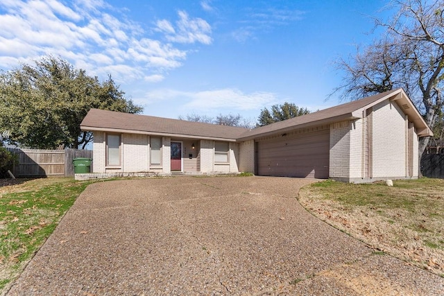 ranch-style house featuring a garage and a front yard