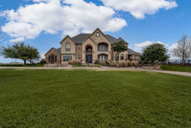 french country home with a front lawn