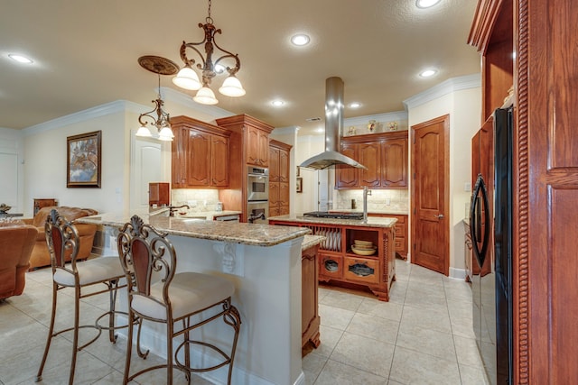 kitchen featuring decorative backsplash, a breakfast bar, appliances with stainless steel finishes, and kitchen peninsula