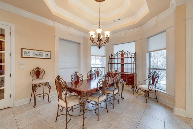 dining space featuring crown molding, light tile patterned floors, a notable chandelier, and a raised ceiling