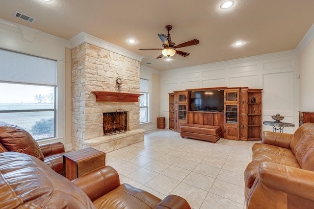 living room with ceiling fan, light tile patterned floors, crown molding, and a fireplace