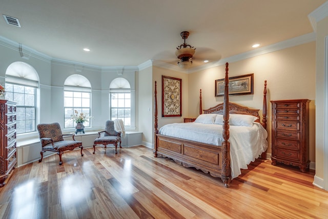 bedroom featuring ceiling fan, light hardwood / wood-style flooring, and multiple windows