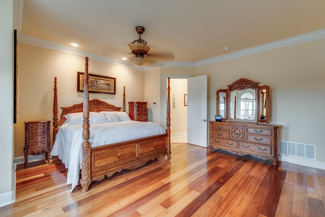 bedroom with hardwood / wood-style flooring, ceiling fan, and crown molding