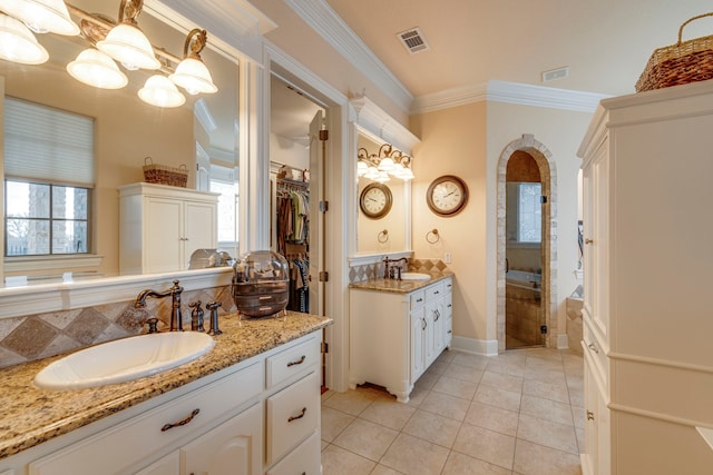 bathroom featuring ornamental molding, tile patterned floors, a wealth of natural light, and vanity