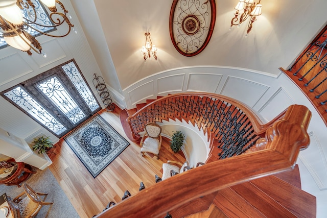 staircase featuring hardwood / wood-style flooring and a high ceiling