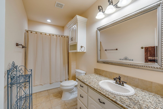 full bathroom featuring tile patterned floors, toilet, vanity, and shower / bath combo