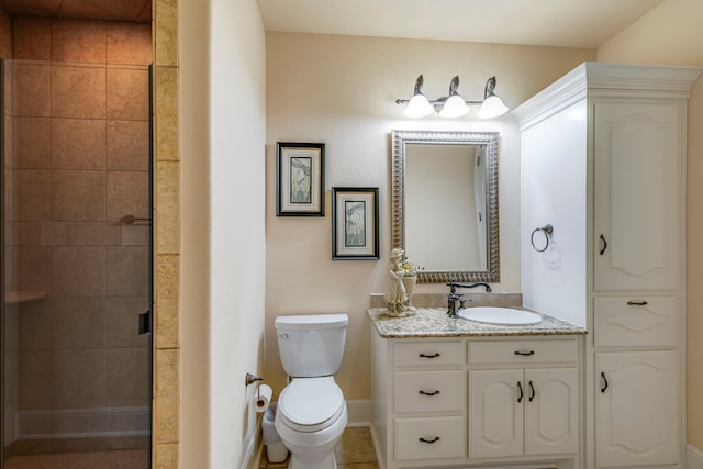 bathroom featuring walk in shower, vanity, toilet, and tile patterned flooring