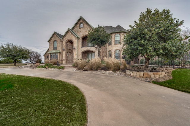 french country style house with a front lawn