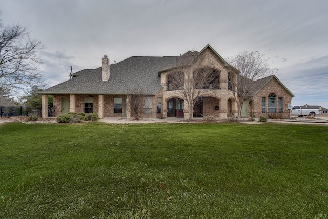 french provincial home with a front lawn