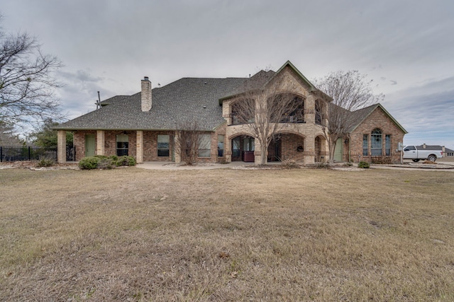 french country inspired facade with a front yard