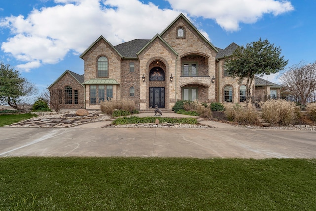 french country home with a front yard