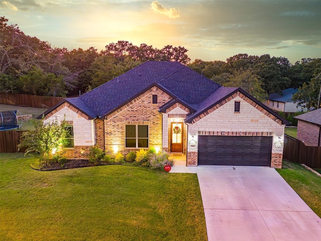 view of front of property featuring a garage and a yard