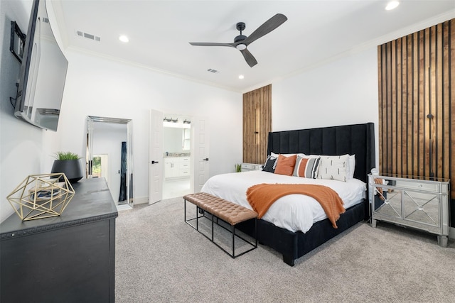 bedroom with carpet flooring, connected bathroom, ceiling fan, and ornamental molding