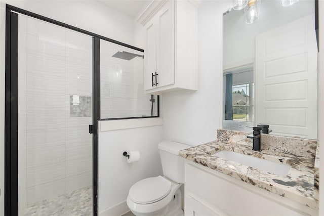 bathroom with vanity, toilet, and an enclosed shower