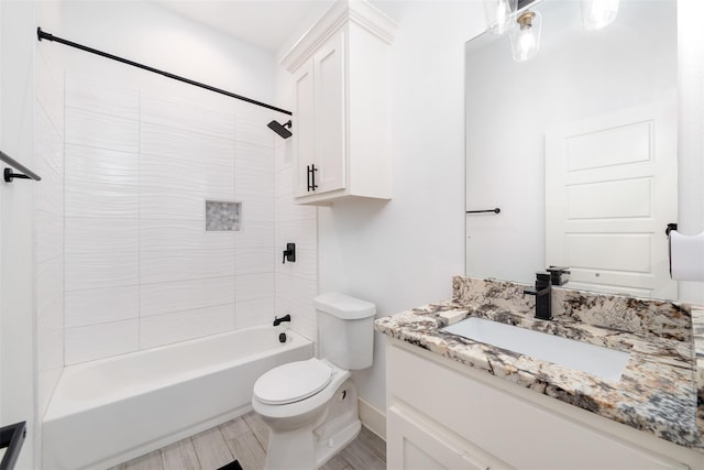 full bathroom featuring vanity, toilet, and tiled shower / bath