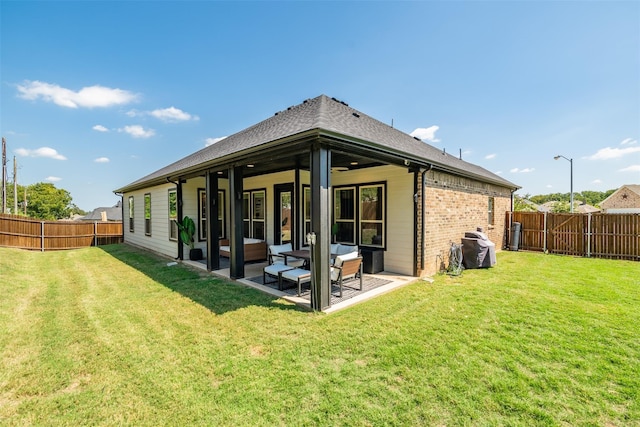 back of house featuring a lawn and a patio