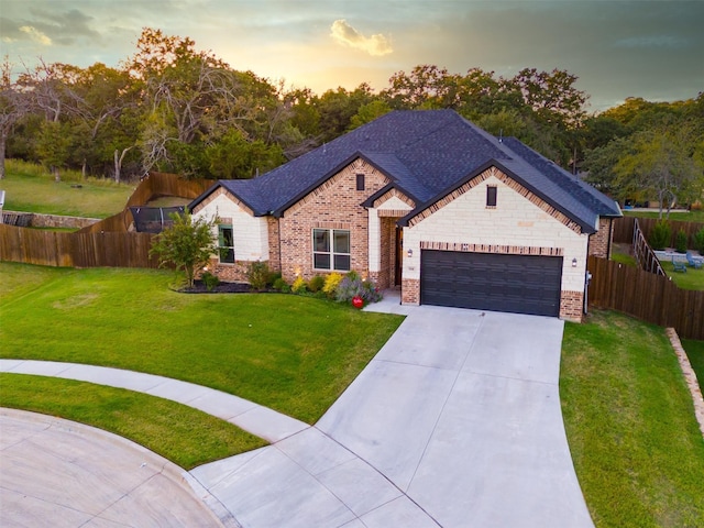 view of front of home featuring a garage and a yard