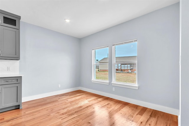 unfurnished room featuring light wood-style flooring and baseboards