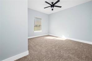 empty room featuring ceiling fan and carpet flooring