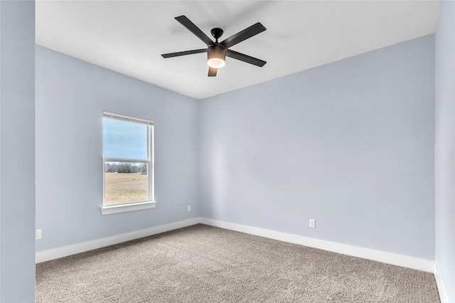 unfurnished room featuring carpet floors, baseboards, and a ceiling fan