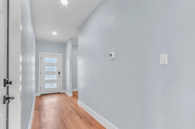 entryway featuring light wood finished floors and baseboards