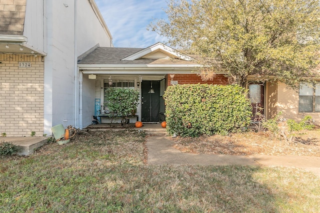 property entrance with a lawn