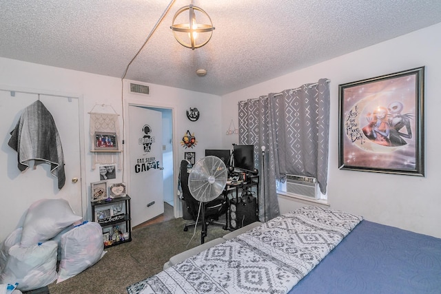 bedroom with carpet flooring, a textured ceiling, and a closet