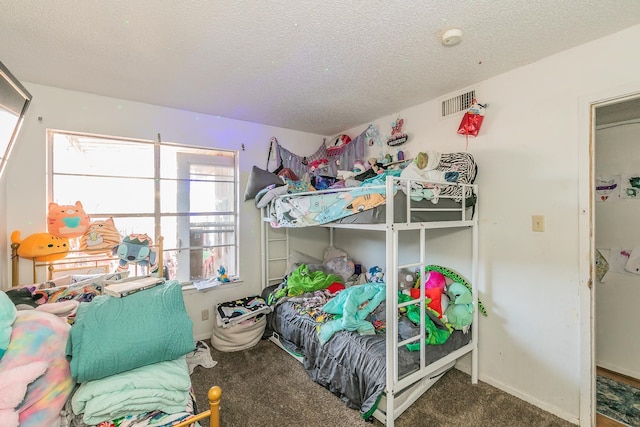 bedroom featuring carpet flooring and a textured ceiling