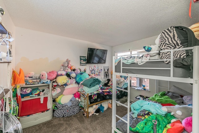 bedroom with carpet floors and a textured ceiling