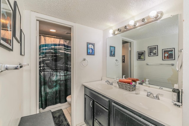 bathroom featuring a textured ceiling, tile patterned flooring, vanity, a shower with curtain, and toilet