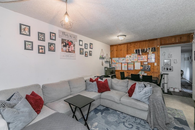 living room featuring a textured ceiling and wood walls