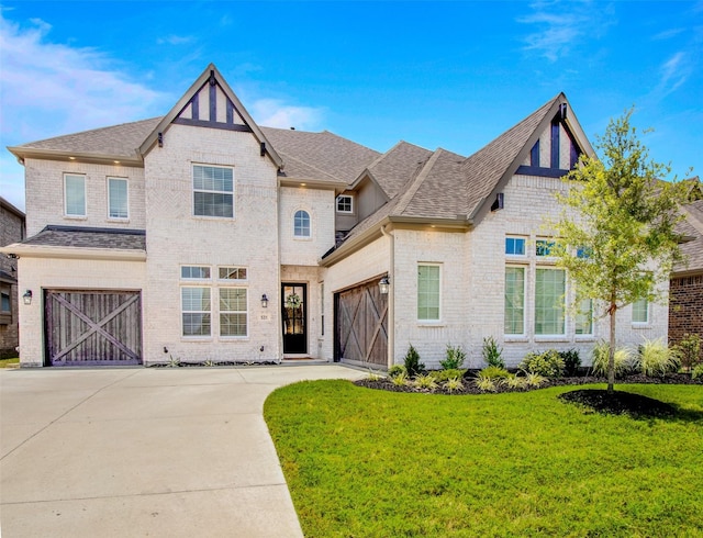 view of front of property with a front yard and a garage