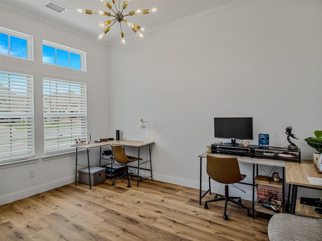 office space featuring light hardwood / wood-style flooring, ornamental molding, and a notable chandelier