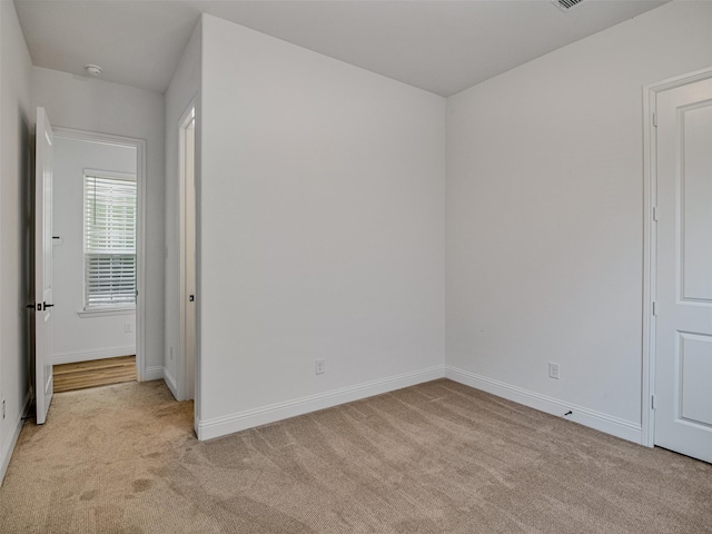 empty room featuring light carpet