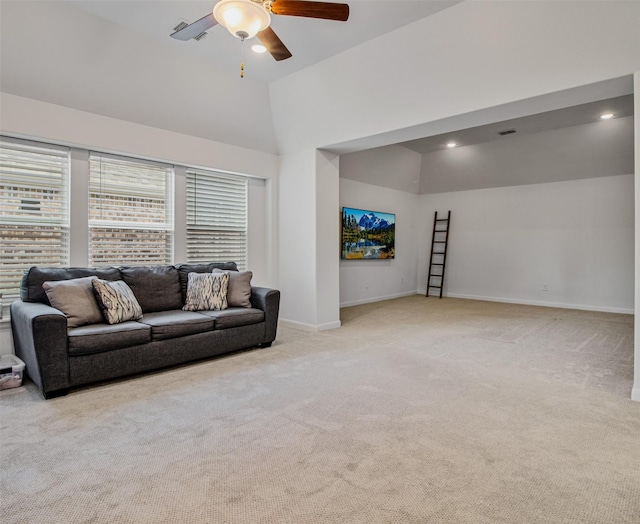 carpeted living room with ceiling fan and lofted ceiling