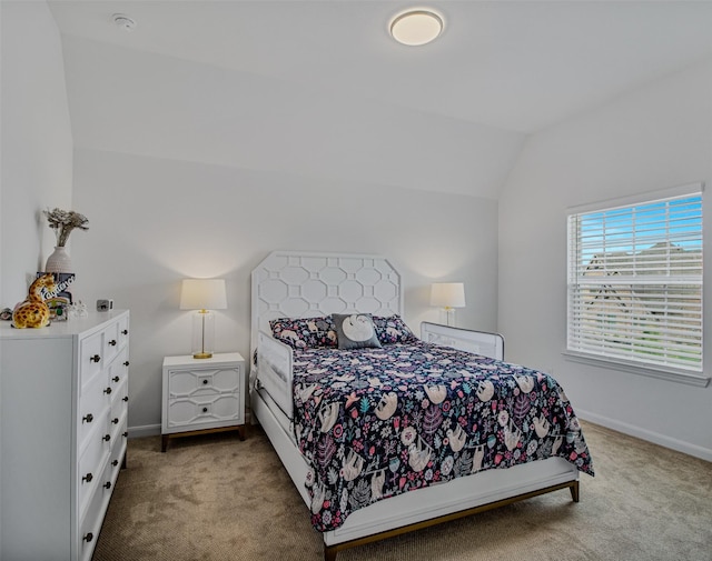 carpeted bedroom with lofted ceiling