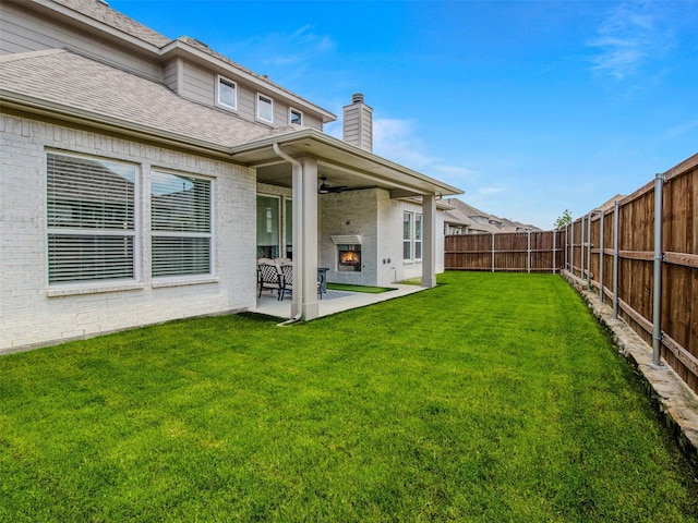 back of house featuring a patio and a yard