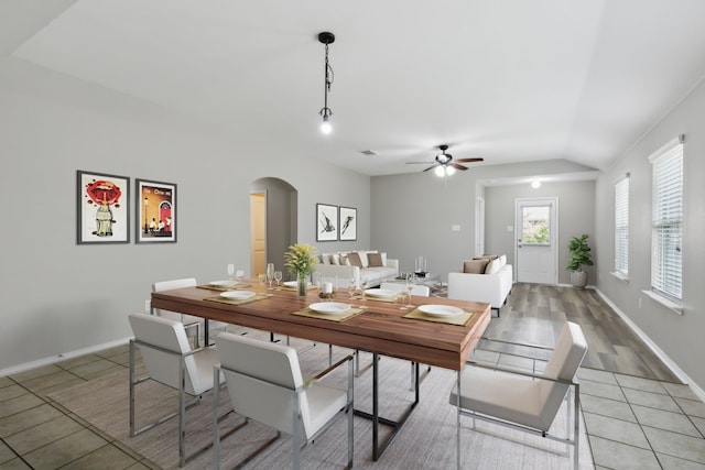 dining room with ceiling fan, light tile patterned floors, and lofted ceiling