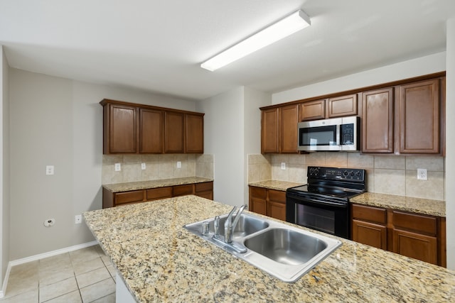 kitchen with light stone countertops, sink, backsplash, black electric range, and light tile patterned flooring