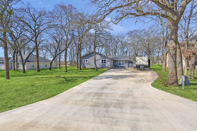 single story home featuring a front lawn and driveway