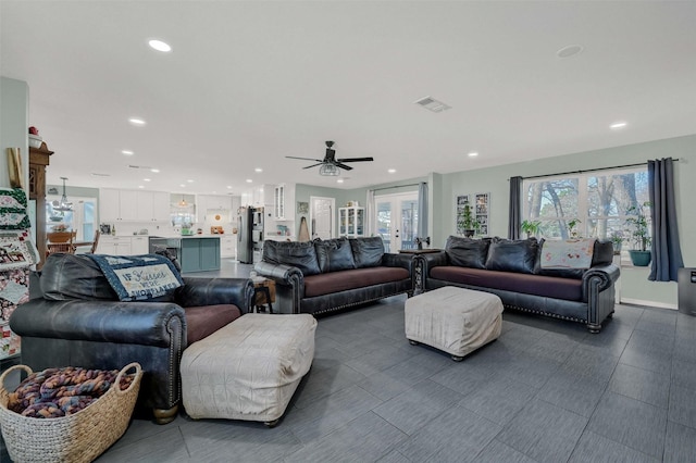 living area with french doors, visible vents, and recessed lighting