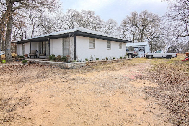 view of side of home with covered porch