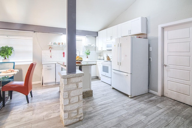 kitchen featuring vaulted ceiling, white cabinetry, white appliances, and backsplash