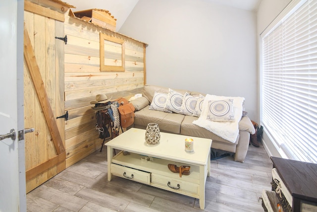 living room with wood walls and light hardwood / wood-style floors