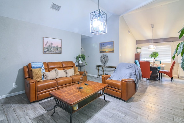 living room featuring light hardwood / wood-style floors and vaulted ceiling