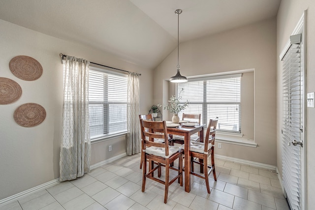 tiled dining space with vaulted ceiling