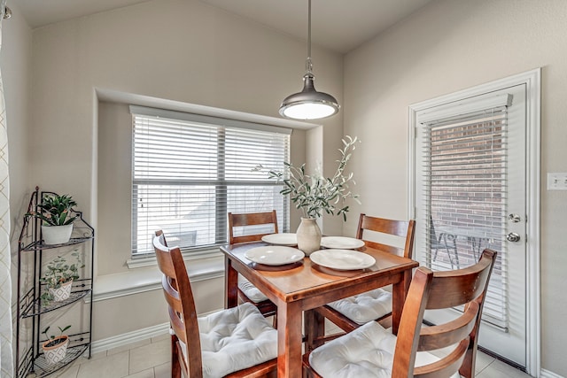 tiled dining area with lofted ceiling