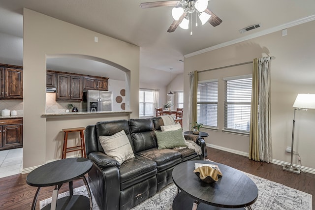 living room featuring lofted ceiling, dark hardwood / wood-style floors, ceiling fan, and crown molding