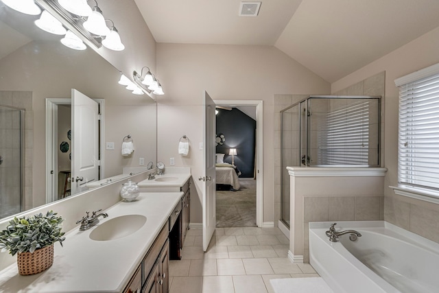 bathroom featuring vaulted ceiling, tile patterned floors, vanity, a notable chandelier, and shower with separate bathtub