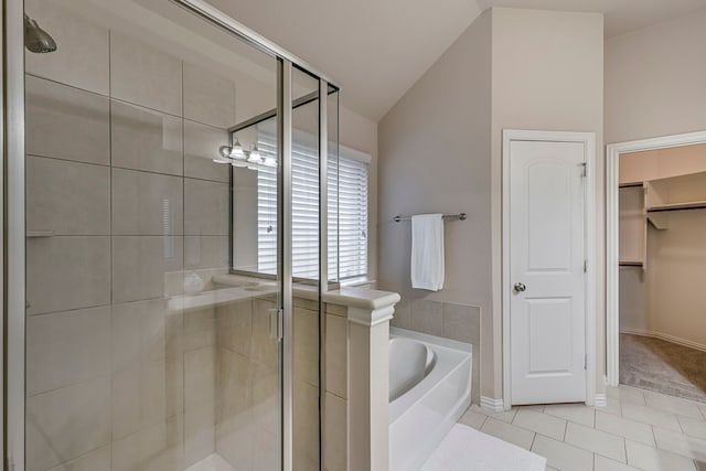 bathroom with vaulted ceiling, tile patterned floors, and shower with separate bathtub